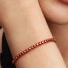 Armband mit Snake Chain und rotem Textilschnurband, 14-karätig vergoldet