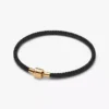 Schimmerndes Armband mit schwarzer Kordel, 14-karätig vergoldet Schimmerndes Armband mit schwarzer Kordel, 14-karätig vergoldet